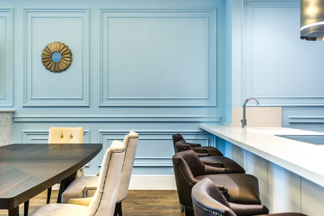 Soft blue painted dining room with panelled walls, London