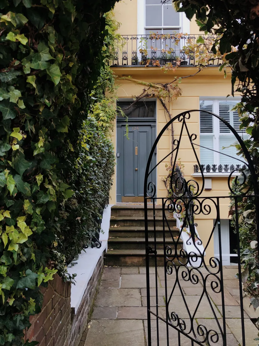 Period townhouse entrance framed by ivy, London