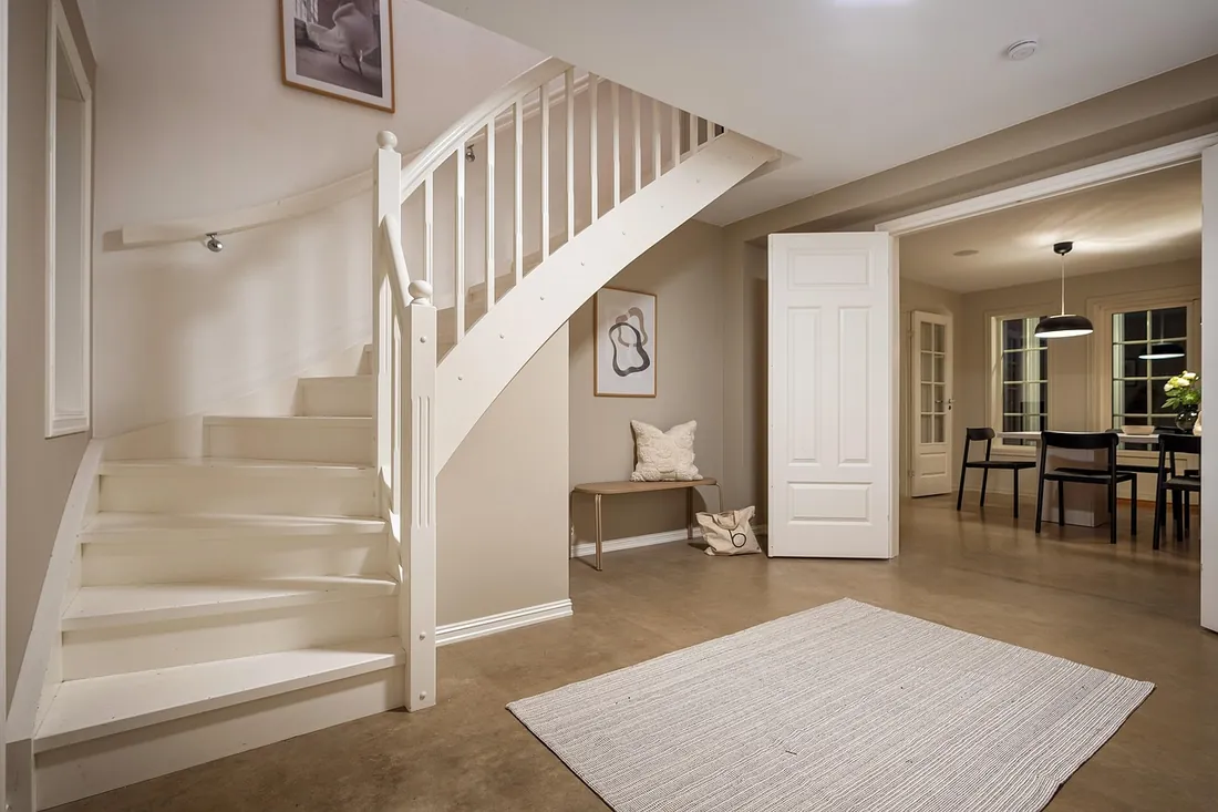 Bright hallway and staircase with painted woodwork, London