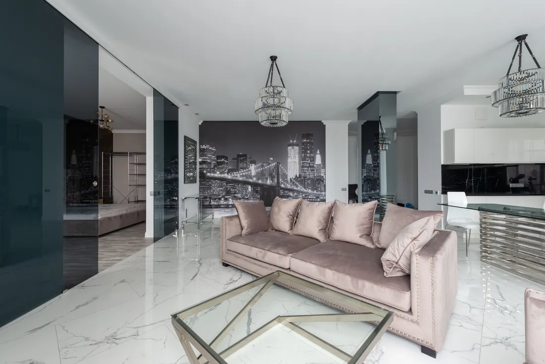 Open-plan flat with a statement chandelier, London