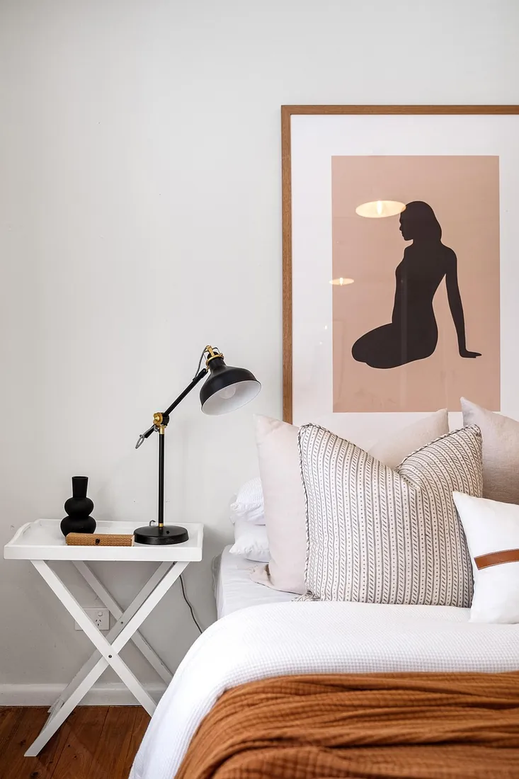 Calm bedroom with fitted furniture and soft tones, London