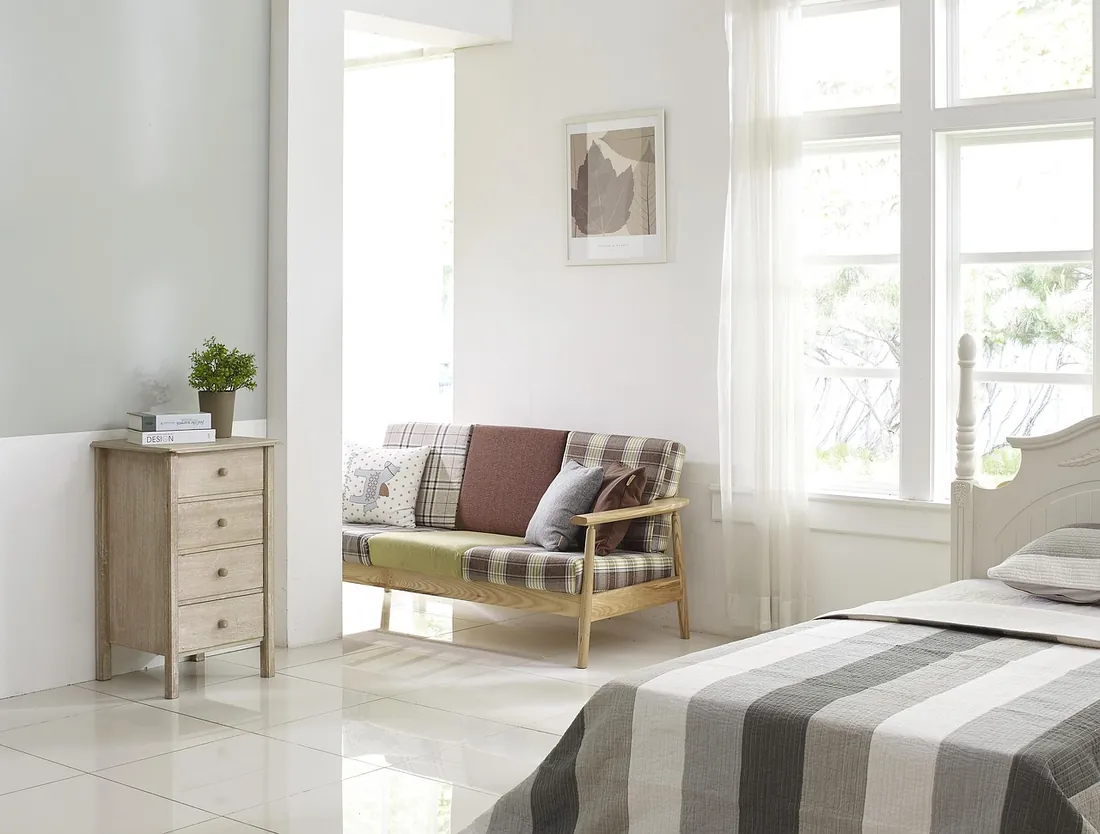 Bedroom with built-in wardrobes and a reading chair, London
