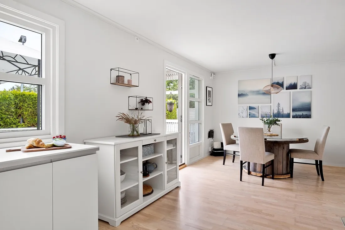Dining room with a credenza and considered colour, London