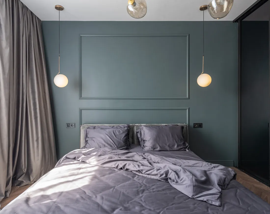 Bedroom with a dark painted feature wall, London