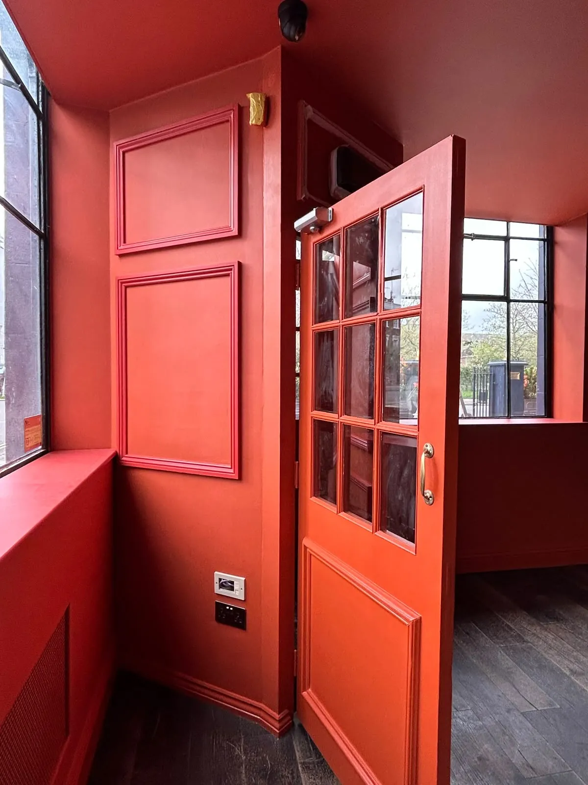 Bar entrance, panelled door in deep red, Notting Hill