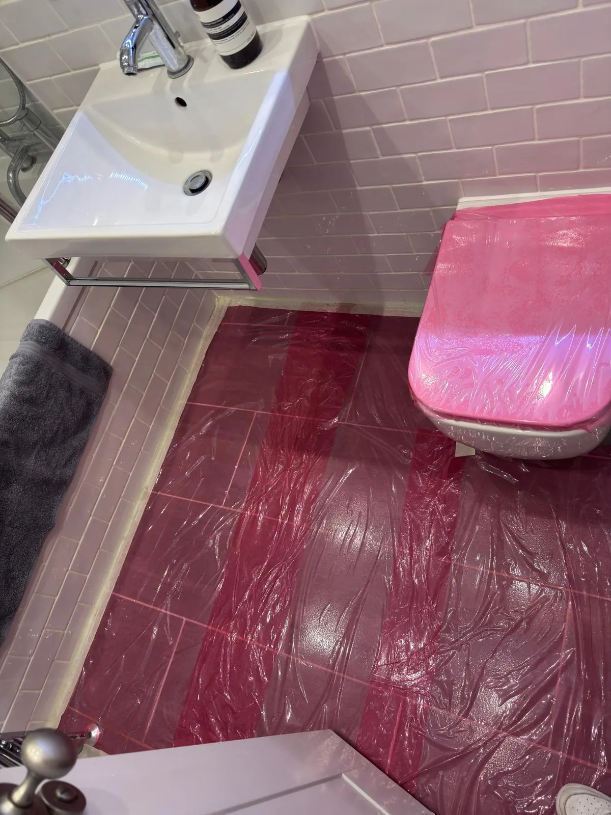 Bathroom fittings and floor sheeted before painting, Belgravia