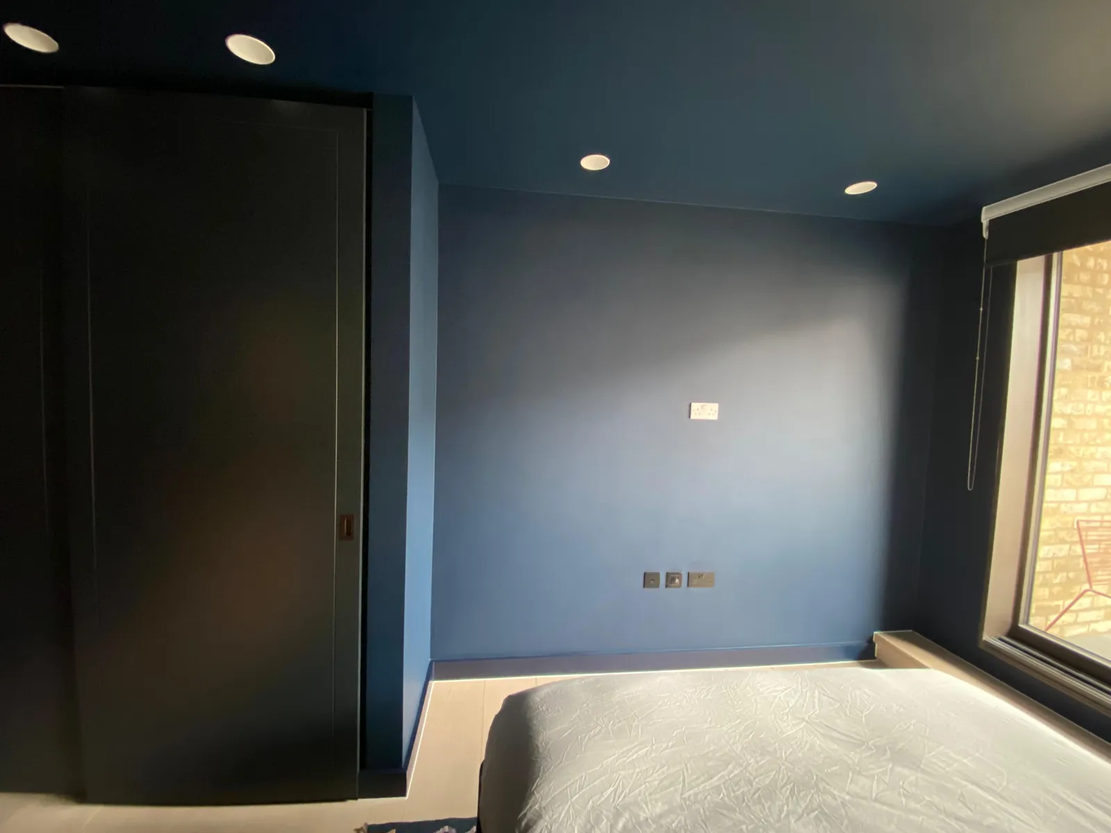 Bedroom in charcoal grey with painted wardrobe, Chelsea
