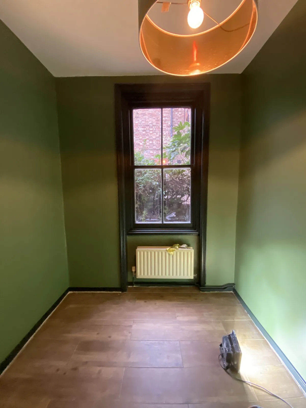 Bedroom in olive green with sash window, Kensington