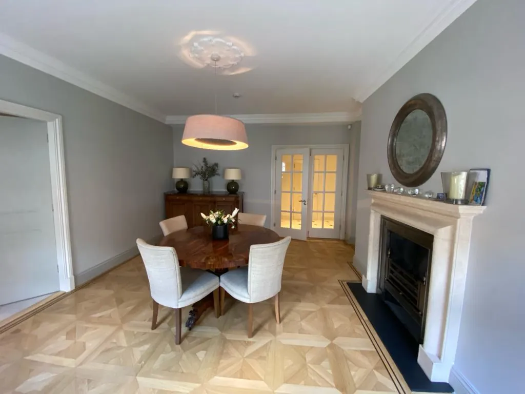 Dining room in pale grey with fireplace, Belgravia