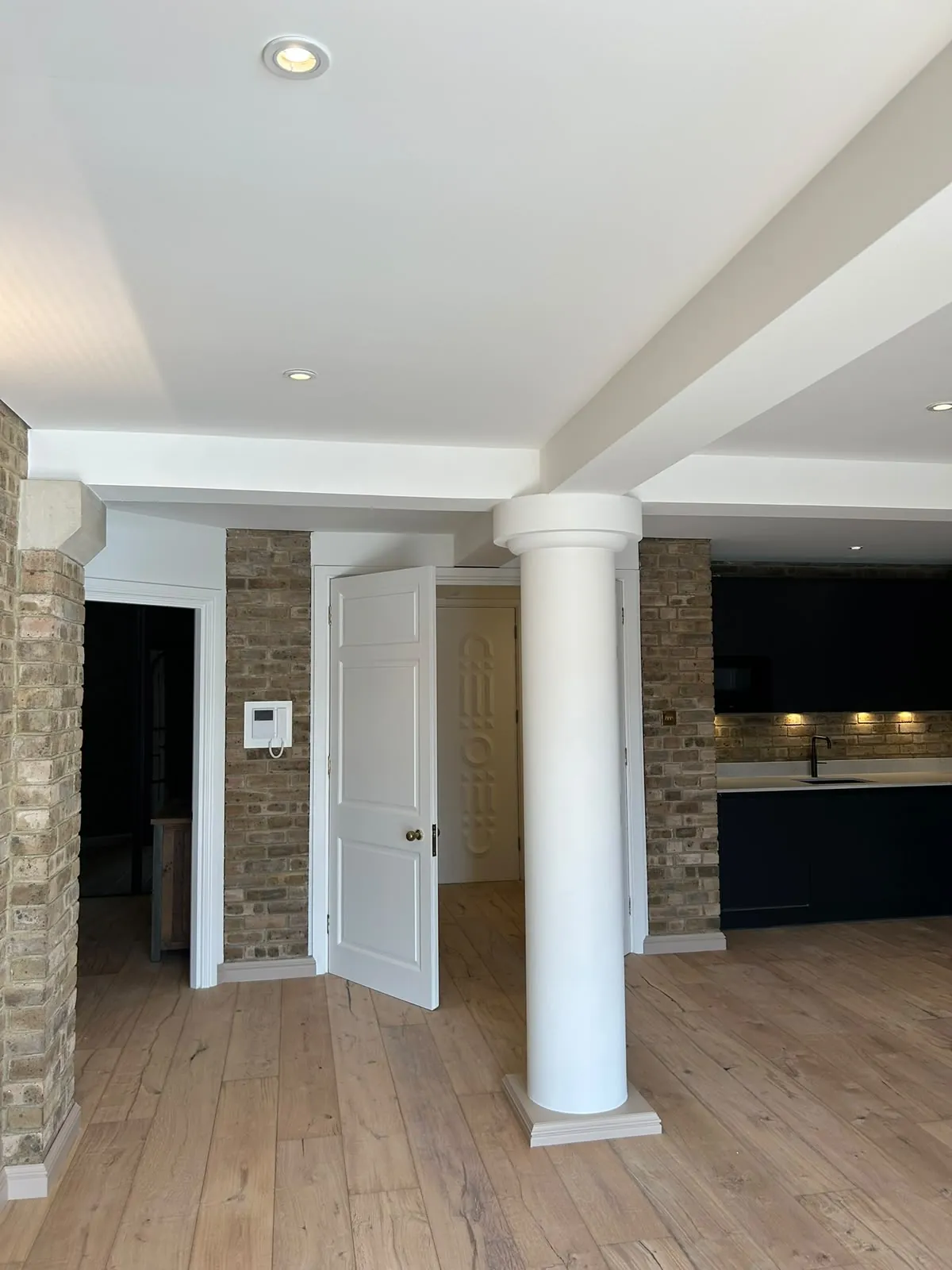 Loft apartment, painted walls beside exposed brick, London