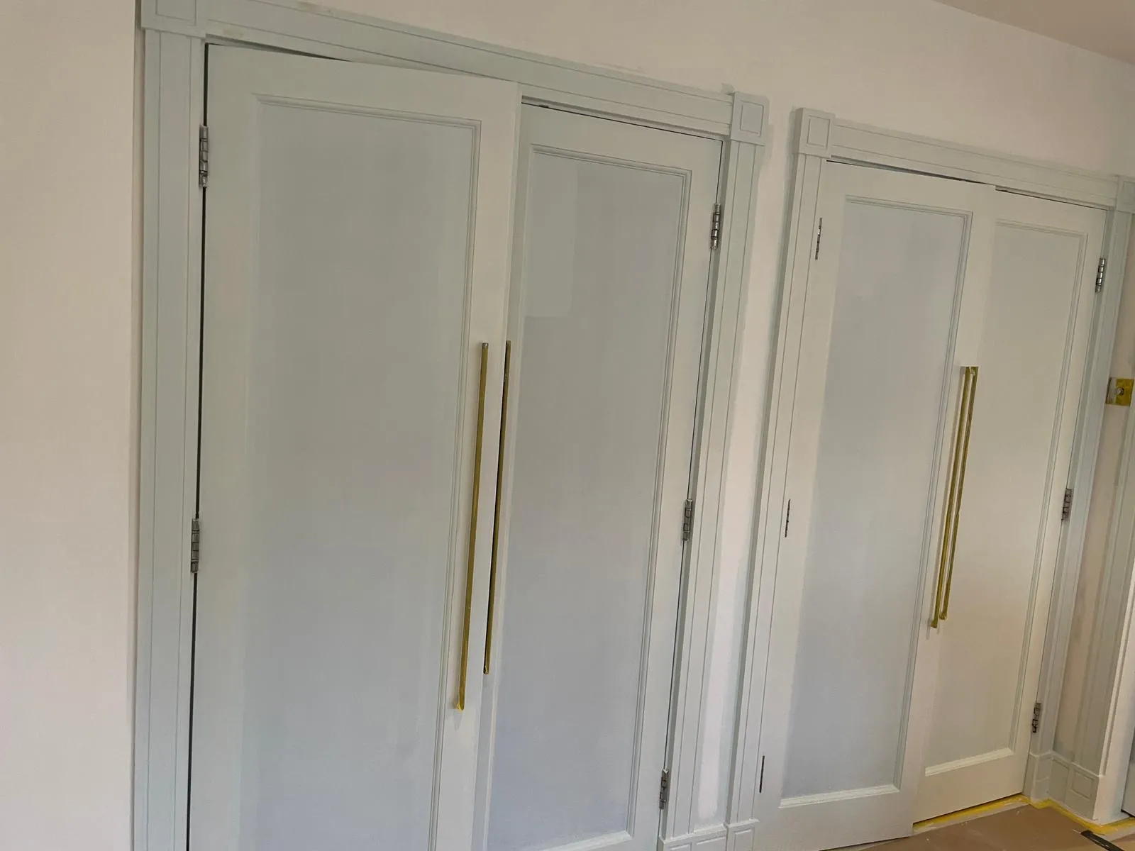 Bedroom with wardrobe doors, walls finished, Hampstead