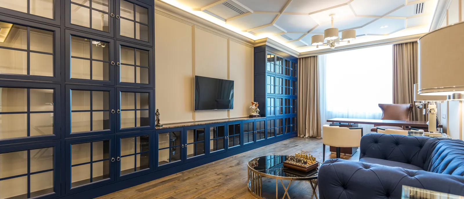 Navy-blue painted panelling and built-in joinery in a London apartment by The Finishing House