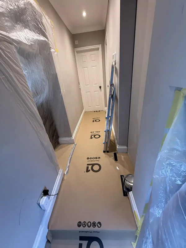 Hallway floor and walls protected before stripping, Chelsea